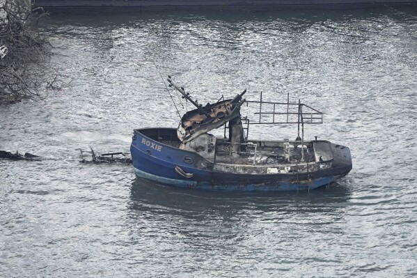 The burnt wildfire wreckage of a boat is seen Thursday, Aug. 10, 2023, in Lahaina, Hawaii. The search of the wildfire wreckage on the Hawaiian island of Maui on Thursday revealed a wasteland of burned out homes and obliterated communities. (AP Photo/Rick Bowmer)