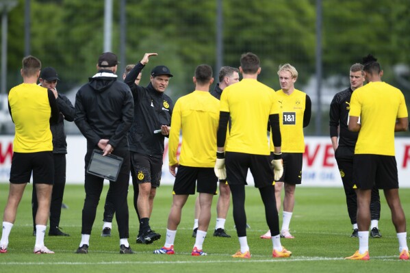 Borussia Dortmund's coach Edin Terzic, center, gives instructions to the players during a team training session in Cologne, Germany, Tuesday, May 28, 2024, ahead of their Champions League final against Real Madrid in London on Saturday. (Marius Becker/dpa via AP)
