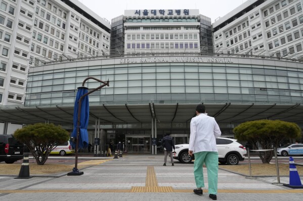 A medical worker walks to enter Seoul National University Hospital in Seoul, South Korea, Thursday, Feb. 29, 2024. South Korea’s government made a last appeal to junior doctors to end a walkout, with hours left to go before the Thursday deadline on its threats to suspend medical licenses and prosecute the strikers. (AP Photo/Ahn Young-joon)