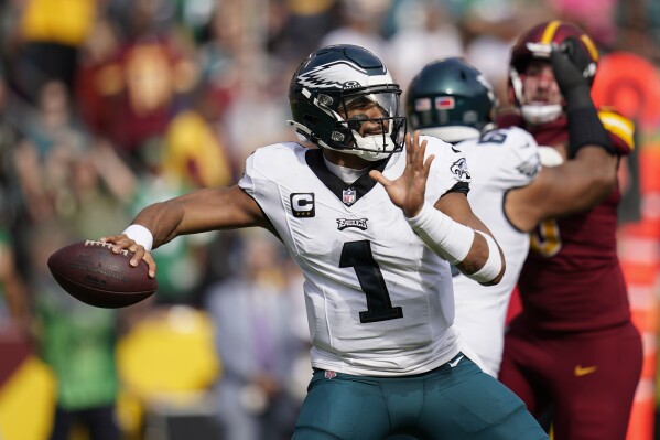 Philadelphia Eagles quarterback Jalen Hurts (1) throwing the ball during the first half of an NFL football game against the Washington Commanders, Sunday, Oct. 29, 2023, in Landover, Md. (AP Photo/Stephanie Scarbrough)