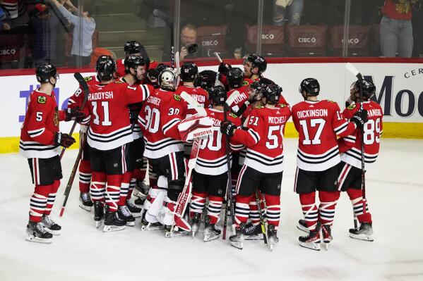 The Chicago Blackhawks celebrate after their overtime win against the Arizona Coyotes in an NHL hockey game Friday, Feb. 10, 2023, in Chicago. (AP Photo/David Banks)