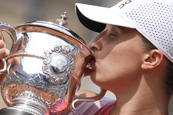 Poland's Iga Swiatek kisses the trophy after winning the women's final of the French Open tennis tournament against Italy's Jasmine Paolini at the Roland Garros stadium in Paris, France, Saturday, June 8, 2024. (AP Photo/Thibault Camus)