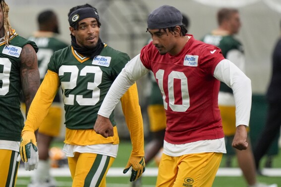 Green Bay Packers' Jordan Love talks to Jaire Alexander during an NFL football practice Tuesday, May 21, 2024, in Green Bay, Wis. (AP Photo/Morry Gash)