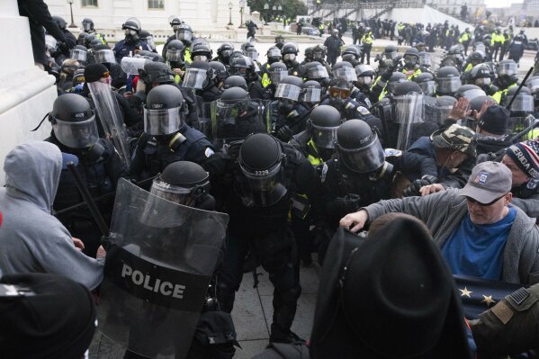 U.S. Capitol Police push back demonstrators who are trying to enter the U.S. Capitol on Wednesday, Jan. 6, 2021, in Washington. (AP Photo/Jose Luis Magana)