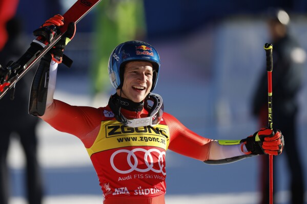 Switzerland's Marco Odermatt celebrates winning an alpine ski, men's World Cup giant slalom race, in Alta Badia, Italy, Monday, Dec. 18, 2023. (AP Photo/Alessandro Trovati)