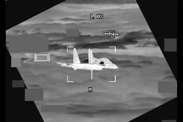 In this image made from video provided by U.S. Indo-Pacific Command, a People’s Republic of China J-11 is seen from a U.S. Air Force B-52 aircraft, over the South China Sea on Oct. 24, 2023. A Chinese fighter jet came within 10 feet of an American B-52 bomber flying over the South China Sea, nearly causing an accident, the U.S. military said, underscoring the potential for a mishap as both countries vie for influence in the region.(U.S. Indo-Pacific Command via AP)