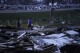 People walk through debris from severe storms Friday, March 15, 2024, in Lakeview, Ohio. (AP Photo/Joshua A. Bickel)