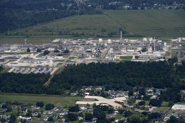 FILE - The Fifth Ward Elementary School and residential neighborhoods sit near the Denka Performance Elastomer Plant, back, in Reserve, La., Sept. 23, 2022. In what could prove a significant move for communities facing air pollution, the Environmental Protection Agency proposed on Thursday, April 6, 2023, that chemical plants nationwide measure certain hazardous compounds that cross beyond their property lines and reduce them when they are too high. (AP Photo/Gerald Herbert, File)