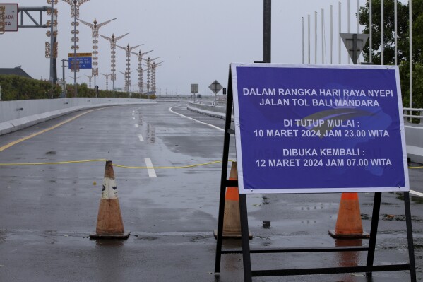 A signboard on a toll road reads "Temporarily closed for Nyepi," in Bali, Indonesia on Monday, March 11, 2024. Airports closed for 24 hours, the internet was turned off and streets were empty as the predominantly Hindu island of Bali in Muslim-majority Indonesia marked its New Year with an annual Day of Silence, called Nyepi, part of six days of extensive New Year rituals. (AP Photo/Firdia Lisnawati)