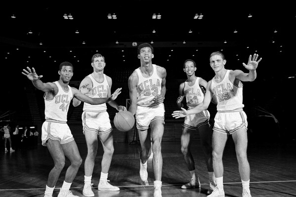 FILE - Lew Alcindor (33), later known as Kareem Abdul Jabbar, poses with his UCLA teammates as basketball practice gets underway in Los Angeles, Oct. 14, 1966. Players from left are, Mike Warren (44), a guard from South Bend, Ind.; Mike Lynn (35), forward from Covina, Ca.; Alcindor; Edgar Lacey (54), forward from Los Angeles; and Don Saffer (25), guard from Los Angeles. (AP Photo/File)