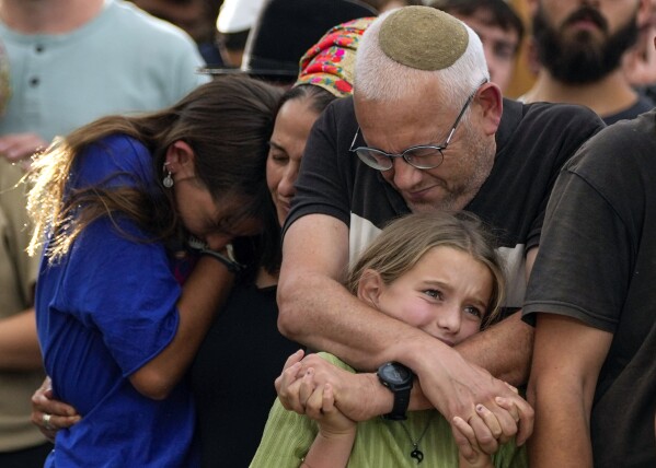 Family members mourn during the funeral of Israeli soldier Shilo Rauchberger at the Mount Herzl cemetery in Jerusalem, Thursday, Oct. 12, 2023. (AP Photo/Francisco Seco)