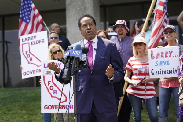 FILE - In this July 13, 2021, file photo, radio talk show host Larry Elder speaks to supporters during a campaign stop in Norwalk, Calif. Elder, the leading Republican candidate in the California recall election that could remove Democratic Gov. Gavin Newsom from office, reported income of over $100,000 in the last year from business interests that included media and film companies and a string of speeches to Republican and conservative groups, documents showed Tuesday, Aug. 17, 2021. (AP Photo/Marcio Jose Sanchez, File)