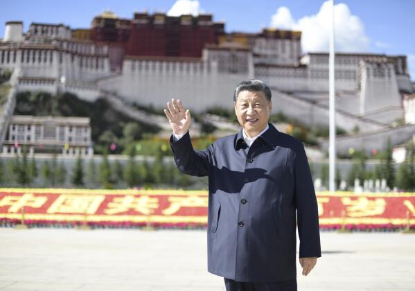 In this July 22, 2021 photo released by China's Xinhua News Agency, Chinese President Xi Jinping waves while visiting a public square below the Potala Palace in Lhasa in western China's Tibet Autonomous Region. Chinese leader Xi Jinping has made a rare visit to Tibet as authorities tighten controls over the Himalayan region's traditional Buddhist culture, accompanied by an accelerated drive for economic development. (Xie Huanchi/Xinhua via AP)
