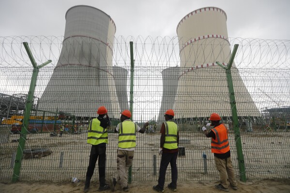 Workers fix barbed wire on the fence of the Rooppur Nuclear Power Plant at Ishwardi in Pabna, Bangladesh, Wednesday, Oct.4, 2023. (AP Photo/Mahmud Hossain Opu)