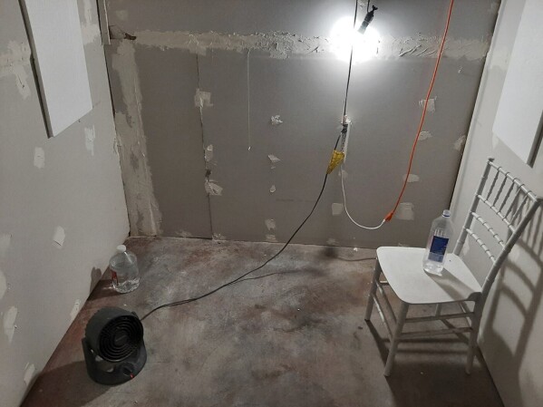 This undated photo provided by the Federal Bureau of Investigation's Portland Field Office shows the interior of a makeshift cinderblock cell in Klamath Falls, Ore., allegedly used by Negasi Zuberi. The FBI said Wednesday, Aug. 2, 2023, that Zuberi, 29, who posed as an undercover police officer kidnapped a woman in Seattle, drove her hundreds of miles to his home in Oregon, and kept her in the cell from which she eventually escaped and found help. Zuberi who was arrested faces a federal interstate kidnapping charge, and authorities said they are looking for additional victims after linking him to sexual assaults in at least four more states. (FBI via AP)