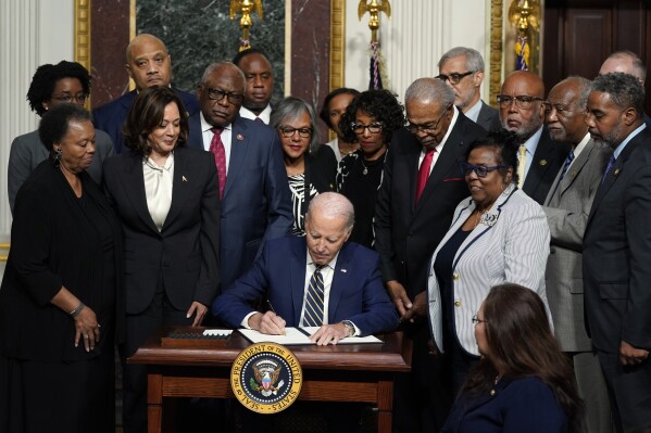 President Joe Biden signs a proclamation to establish the Emmett Till and Mamie Till-Mobley National Monument, in the Indian Treaty Room on the White House campus, Tuesday, July 25, 2023, in Washington. (AP Photo/Evan Vucci)