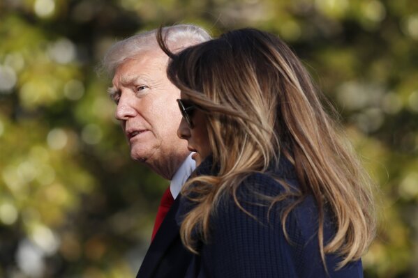 
              In this March 19, 2018, photo, President Donald Trump, accompanied by first lady Melania Trump, walks on the South Lawn of the White House in Washington, on his return from a trip to New Hampshire. Former Playboy model Karen McDougal apologized to Melania Trump for a 10-month affair she claims she had with President Trump that started with him offering her money after the first time they had sex. (AP Photo/Alex Brandon)
            