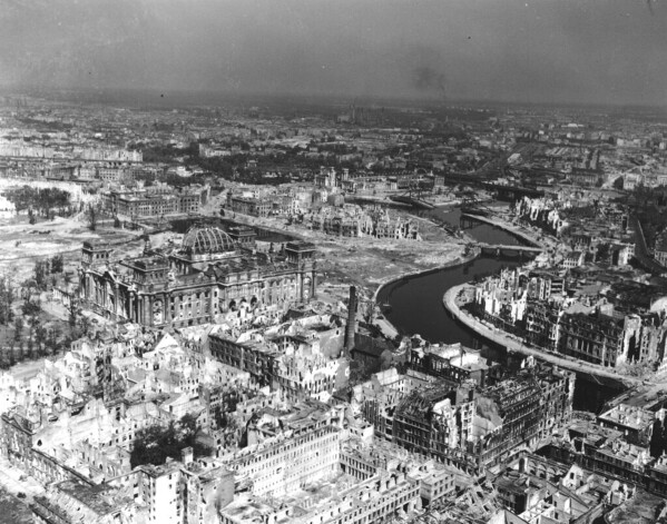 A view taken from a Cub artillery observation plane on July 10, 1945, shows vast areas of destruction in Berlin, after repeated Anglo-American air raids on the German capital. Seen on the left, center, is the heavily damaged building of the German Reichstag with its distinct cupola, in the background center are the remains of Lehrter Bahnhof, one of the city's train stations. (AP Photo, File)