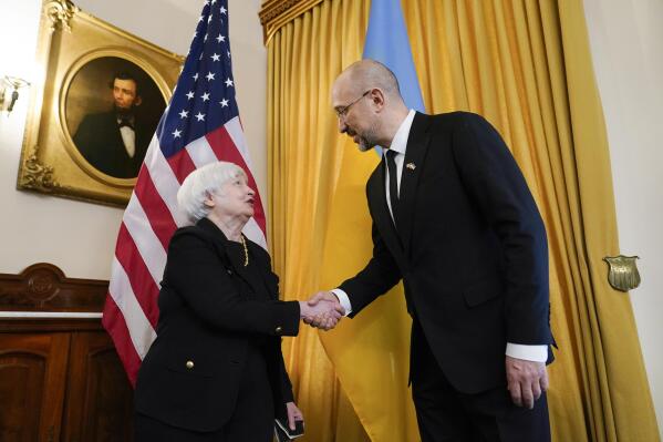 Treasury Secretary Janet Yellen, left, shakes hands with Prime Minister of Ukraine Denys Shmyhal, right, before their meeting at the Treasury Department in Washington, Thursday, April 21, 2022. (AP Photo/Susan Walsh)