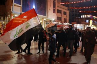 Mourners carry the flag-draped coffins of Iraqi soldiers killed in an attack by gunmen of the Islamic State extremist group in Baqouba in Diyala province during a mass funeral procession inside the shrine of Imam Ali in Najaf, Iraq, Friday, Jan. 21, 2022. Gunmen from the Islamic State extremist group attacked an army barracks in a mountainous area north of Baghdad early Friday, killing 11 soldiers as they slept, the Iraqi military and security officials said. (AP Photo/Anmar Khalil)
