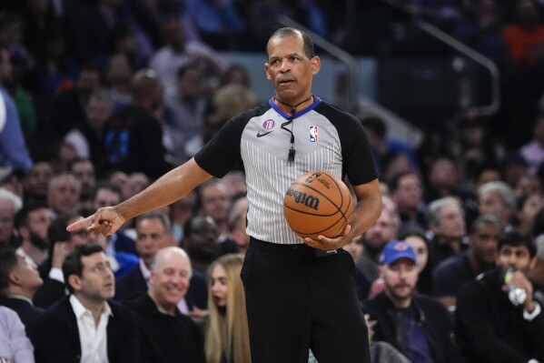 FILE - Referee Eric Lewis gestures during the first half of Game 5 of the NBA basketball Eastern Conference semifinal between the New York Knicks and the Miami Heat, May 10, 2023, in New York. Lewis, one of the NBA's top referees, has retired effective immediately in the wake of a league investigation into whether he used a then-Twitter account to defend himself and other officials from online criticism. The league announced his retirement Wednesday, Aug. 30, 2023. (AP Photo/Frank Franklin II, File)