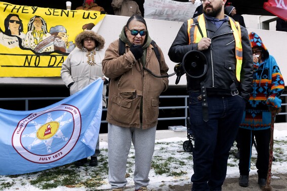 Joe Lafferty, of Iron Lightning, S.D., speaks to a group of Dakota Access Pipeline protesters outside The Radisson Hotel in Bismarck, N.D., on Wednesday, Nov. 1, 2023 prior to a U.S. Army Corps of Engineers public meeting on DAPL. (Darren Gibbins/The Bismarck Tribune via AP)