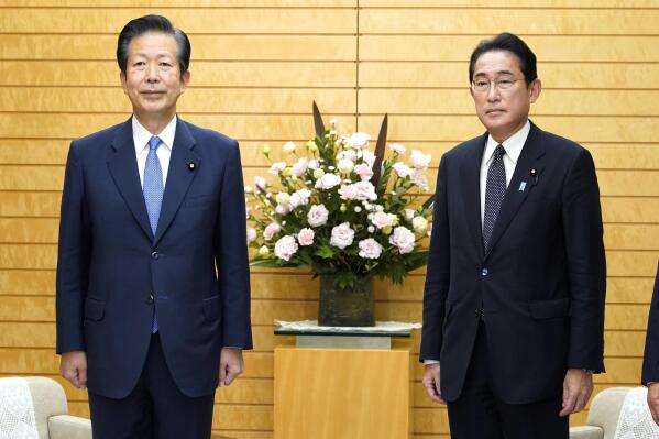 Japanese Prime Minister Fumio Kishida, right, and the leader of Kishida's coalition partner, Natsuo Yamaguchi pose for a photo as they meet to discuss a bill to help victims of the religious group known as the Unification Church, at the prime minister's official residence in Tokyo, Tuesday, Nov. 8, 2022. (Keisuke Hosojima/Kyodo News via AP)