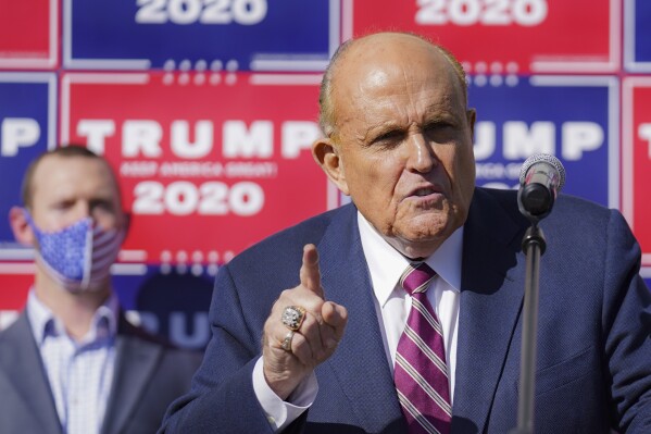FILE - Former New York mayor Rudy Giuliani, a lawyer for President Donald Trump, speaks during a news conference at Four Seasons Total Landscaping on legal challenges to vote counting in Pennsylvania, Nov. 7, 2020, in Philadelphia. A review panel says Giuliani should be disbarred in Washington for how he handled litigation challenging the 2020 election on behalf of then-President Donald Trump. The panel's report was released Friday, July 7, 2023. (AP Photo/John Minchillo, File)