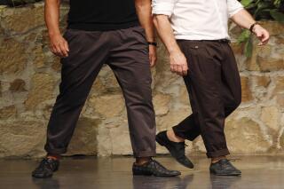 FILE -- In this June 23, 2012 file photo Italian fashion designers Stefano Gabbana, left, and Domenico Dolce take the catwalk after presenting their Dolce & Gabbana men's fashion collection in Milan, Italy.  (AP Photo/Luca Bruno, file)