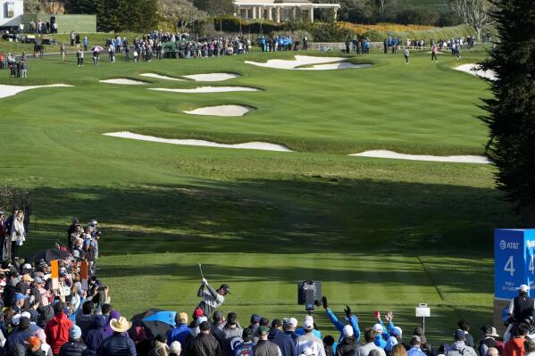 Justin Rose, front center left, of England, prepares to hit a drive from the fourth tee of the Pebble Beach Golf Links during the fourth round of the AT&T Pebble Beach Pro-Am golf tournament in Pebble Beach, Calif., Sunday, Feb. 5, 2023. (AP Photo/Godofredo A. Vásquez)