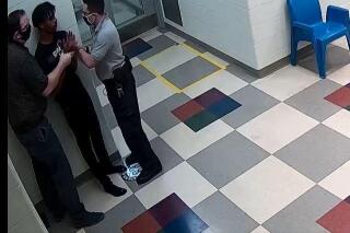 This still image from a security camera provided by Sedgwick County shows Cedric Lofton talking with staff on Sept. 24, 2021 at the Sedgwick County Juvenile Intake and Assessment Center in Wichita, Kan. A community task force reviewing the death of the Black teenager who was restrained for more than 30 minutes learned that a police officer changed his answers on a form that otherwise would have led police to take the teen to a hospital instead of booking him into the detention center. The Wichita Eagle reported Sunday, April 10, 2022 that a Sedgwick County official who oversees admissions into the detention center told the task force that the officer initially reported there were signs that Lofton needed medical attention  but he changed his answers after being told the teen would need a medical review if he said yes on the form. (Sedgwick County via AP)
