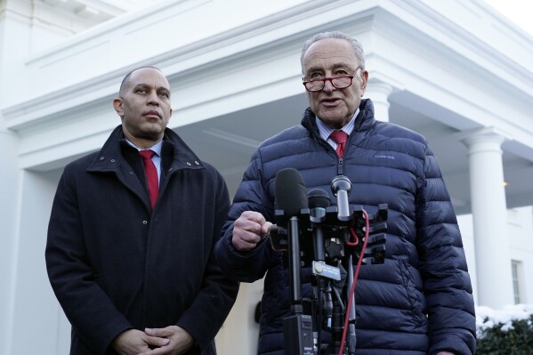 FILE - Senate Majority Leader Chuck Schumer of N.Y., right, and House Minority Leader Hakeem Jeffries of N.Y., talk to reporters outside the West Wing of the White House in Washington, Jan. 17, 2024, following a meeting with President Joe Biden. Biden is convening the top four congressional leaders at the White House on Feb. 27 to discuss the emergency aid package for Ukraine and Israel, as well as avoiding a government shutdown next month. (AP Photo/Susan Walsh, File)