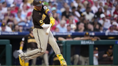 San Diego Padres' Manny Machado hits a home run against Philadelphia Phillies relief pitcher Jeff Hoffman during the sixth inning of a baseball game, Friday, July 14, 2023, in Philadelphia. (AP Photo/Matt Slocum)