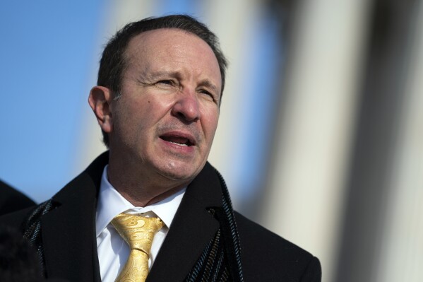 FILE - Louisiana Attorney General Jeff Landry talks to reporters outside the Supreme Court, Jan. 7, 2022, in Washington. Landry, the early GOP front runner in the state’s governor race, attended his first televised gubernatorial debate Friday evening, Sept. 15 2023, opening the door to political attacks from a crowded room of candidates. (AP Photo/Evan Vucci, File)