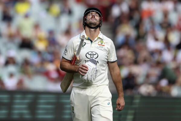 Australia's Mitchell Marsh walks off after he is caught out by Pakistan on 96 runs during the third day of their cricket test match in Melbourne, Thursday, Dec. 28, 2023. (AP Photo/Asanka Brendon Ratnayake)