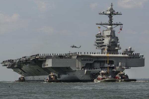 FILE - The aircraft carrier USS Gerald R. Ford heads to the Norfolk, Va., naval station on April 14, 2017. The USS Gerald R. Ford leaves the world's largest Navy base in Norfolk on Monday, Oct. 3, 2022, along with destroyers and other warships, the U.S. Navy said in a statement Thursday, Sept. 29, 2022. The carrier strike group will join ships in the Atlantic Ocean from countries that include France, Germany and Sweden for various exercises, such as anti-submarine warfare. (Bill Tiernan/The Virginian-Pilot via AP, File)