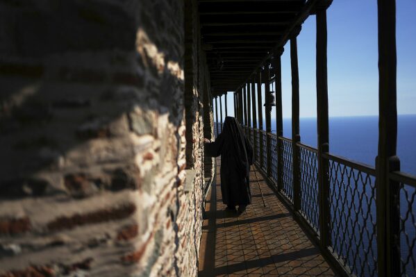 A monk walks along a balcony at the Simonopetra, or Simonos Petra Monastery, home of the all-male autonomous community Agion Oros, or Holy Mountain, on the peninsula of Mount Athos in northern Greece, April 13, 2025. (AP Photo/Thanassis Stavrakis)