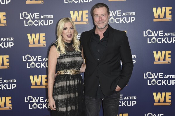 FILE - Tori Spelling, left, and Dean McDermott attend Real Love: Relationship Reality TV's Past, Present and Future on Dec. 11, 2018, in Beverly Hills, Calif. Spelling filed for divorce Friday from her husband and former reality TV co-star McDermott. The former “Beverly Hills 90210” actor petitioned to end the marriage of nearly 18 years in Los Angeles Superior Court. She cited irreconcilable differences as the reason. (Photo by Richard Shotwell/Invision/AP, File)