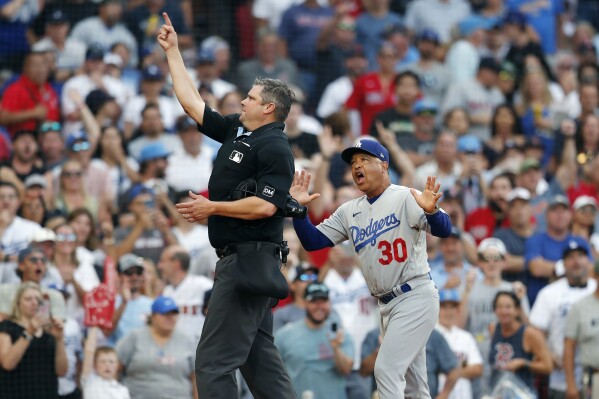 Home plate umpire Jordan Baker ejects Los Angeles Dodgers manager Dave Roberts (30) during the eighth inning of a baseball game against the Boston Red Sox, Saturday, Aug. 26, 2023, in Boston. (AP Photo/Michael Dwyer)