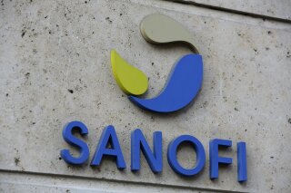 FILE - In this photo Nov.30, 2020 file photo the logo of French drug maker Sanofi is picture at the company's headquarters, in Paris. French drug maker Sanofi said Wednesday it will help manufacture 125 million doses of the coronavirus vaccine developed by rivals Pfizer and BioNTech, while its own vaccine candidate faces delays. (AP Photo/Thibault Camus, File)