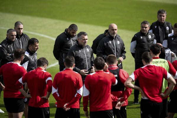 Georgia's head coach Willy Sagnol, center, speaks to the team during training session of Georgia's national soccer team in Velbert, Germany, Thursday, June 13, 2024. (Fabian Strauch/dpa via AP)