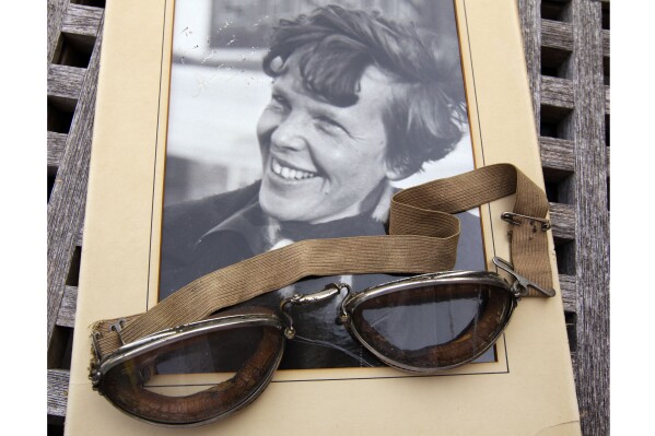 An original, unpublished personal photo of Amelia Earhart dated 1937, along with goggles she was wearing during her first plane crash are seen Friday, Sept. 9, 2011, at Clars Auction Gallery in Oakland, Calif. (AP Photo/Ben Margot, File)