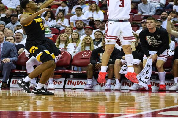 Wisconsin's Connor Essegian (3) shoots against Iowa's Tony Perkins (11) during the second half of an NCAA college basketball game Wednesday, Feb. 22, 2023, in Madison, Wis. (AP Photo/Andy Manis)