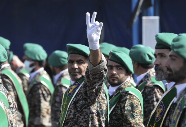 A member of Iran's Basij paramilitary force flashes a victory sign during a military parade outside of Tehran, Iran, on Sept. 22, 2022. (AP Photo/Vahid Salemi, File)