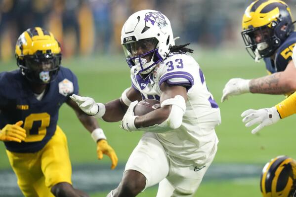 TCU running back Kendre Miller (33) runs against Michigan during the first half of the Fiesta Bowl NCAA college football semifinal playoff game, Saturday, Dec. 31, 2022, in Glendale, Ariz. (AP Photo/Ross D. Franklin)