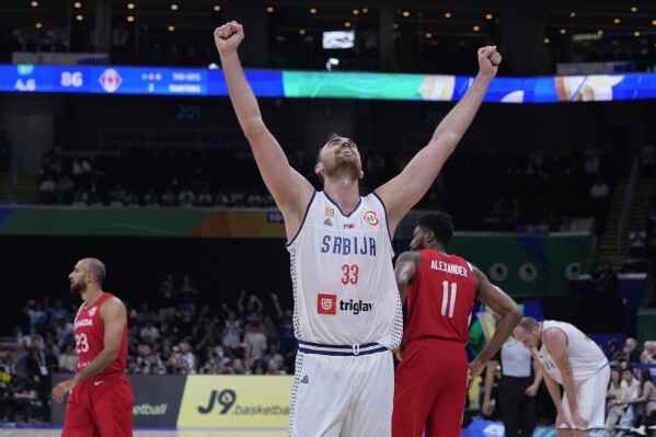 Serbia center Nikola Milutinov celebrates his team's win over Canada in a Basketball World Cup semi final game in Manila, Philippines, Friday, Sept. 8, 2023. (AP Photo/Michael Conroy)
