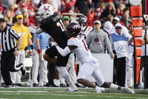 Virginia Tech cornerback Derrick Canteen (13) tries to bring down Louisville running back Isaac Guerendo (23) during the second half of an NCAA college football game in Louisville, Ky., Saturday, Nov. 4, 2023. Louisville won 34-3. (AP Photo/Timothy D. Easley)