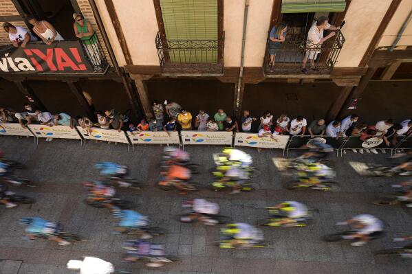 La Vuelta's cyclists cross Major street during the fourth stage between Burgo de Osma and Molina de Aragon, 163,9 kilometers of La Vuelta cycling race in Burgo de Osma, northern Spain, Tuesday, Aug. 17, 2021. (AP Photo/Alvaro Barrientos)