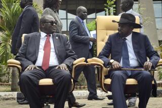 FILE - South Sudan's then First Vice President Riek Machar, left, looks across at President Salva Kiir, right, as they sit to be photographed following the first meeting of a transitional coalition government, in the capital Juba, South Sudan on April 29, 2016. Parties to the peace deal ending South Sudan's devastating civil war on Thursday, Aug. 4, 2022 again delayed the country's first elections since independence by extending the transitional period by two years. (AP Photo/Jason Patinkin, File)