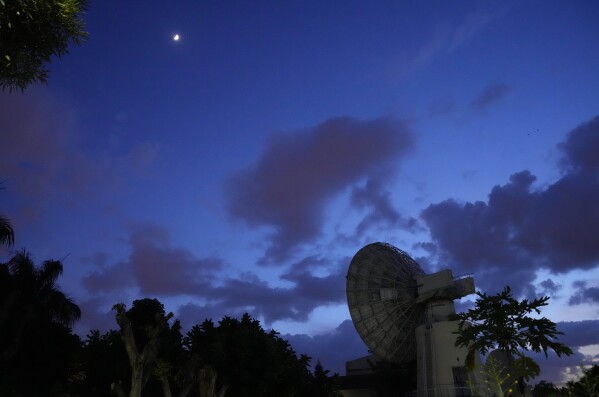 The moon shines over Indian Space Research Organization (ISRO) Telemetry, Tracking and Command Network facility in Bengaluru, India, Wednesday, Aug. 23, 2023. (AP Photo/Aijaz Rahi)